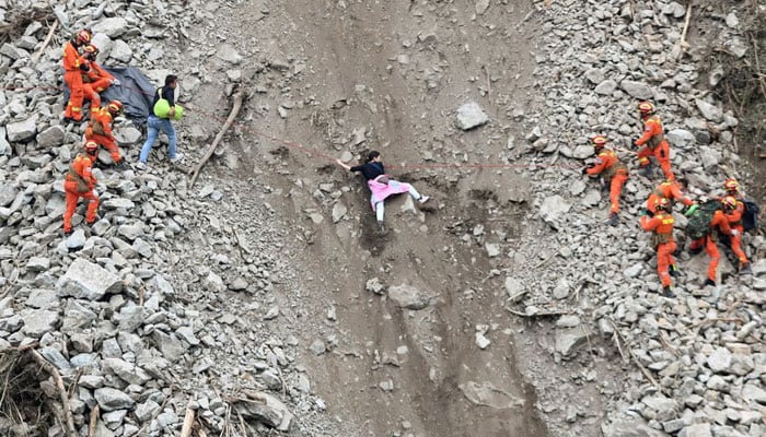 Rescue workers evacuate quake-affected residents at the site of a landslide near Moxi town, following a 6.8-magnitude earthquake in Luding county, Ganzi Tibetan Autonomous Prefecture, Sichuan province, China September 6, 2022. &mdash; Reuters