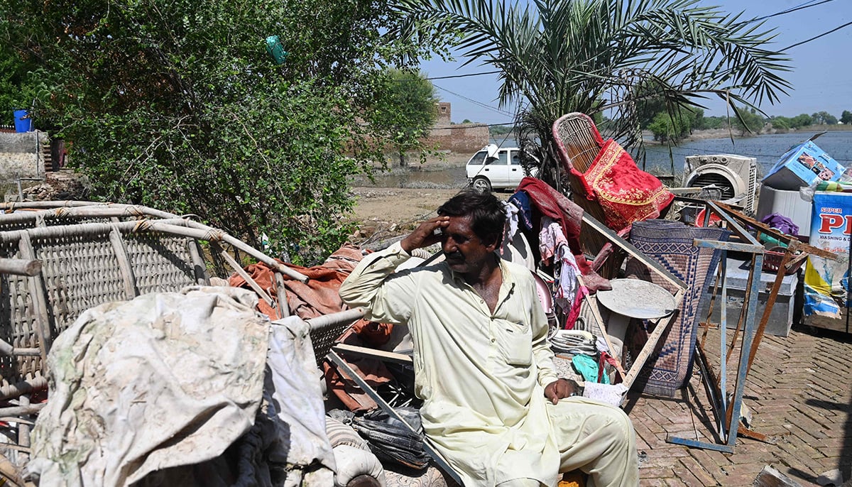 Mureed Hussain sits with the dowry furniture of his daughter Nousheen, which was damaged by flood waters at his house in Fazilpur, Rajanpur district of Punjab province on September 3, 2022. &mdash; AFP