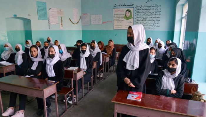 Girls attend a class after their school reopened in Kabul on 23 March 2022. The Taliban ordered girls secondary schools to shut down just hours later. — AFP
