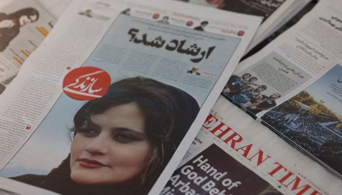 A newspaper with a cover picture of Mahsa Amini, a woman who died after being arrested by the Islamic republics morality police is seen in Tehran, Iran September 18, 2022. — Reuters