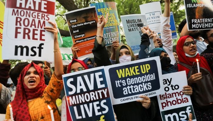 Citizens shout slogans and hold placards during a peace vigil organized by citizens against hate crimes and violence against Muslims, New Delhi, India, April 16, 2022. — Reuters