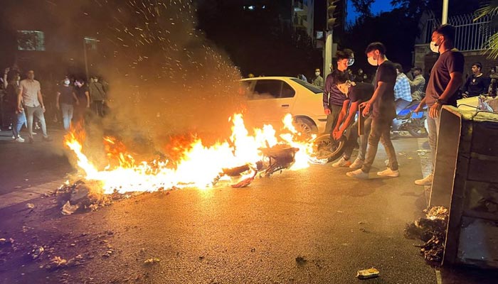 A police motorcycle burns during a protest over the death of Mahsa Amini, a woman who died after being arrested by the Islamic republics morality police, in Tehran, Iran September 19, 2022. — Reuters
