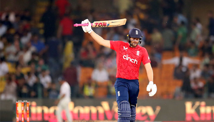 Englands Dawid Malan raises his bat after scoring a half century against Pakistan at the Gadaffi Stadium in Lahore. — PCB