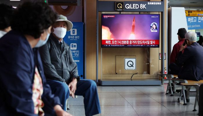 People watch a TV broadcasting a news report on North Korea firing a ballistic missile over Japan, at a railway station in Seoul, South Korea, October 4, 2022.—  Reuters