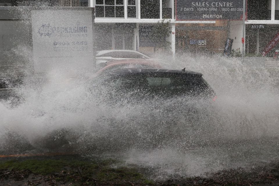 Vehicles drive through floodwaters as heavy rains affect Sydney, Australia, October 6, 2022.