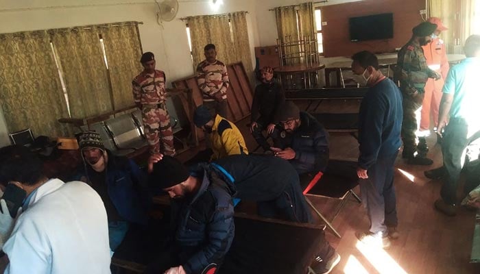 Evacuees (L) rest after receiving first aid at the ITBP Matli helipad station on October 5, 2022. — AFP/File