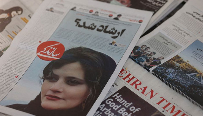 A newspaper with a cover picture of Mahsa Amini, a woman who died after being arrested by the Islamic republics morality police is seen in Tehran, Iran September 18, 2022. — Reuters