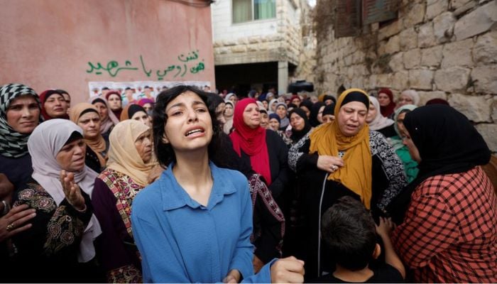Mourners attend the funeral of Palestinian Mahdi Ladado, 17, who was killed by Israeli forces during clashes, near Ramallah in the Israeli-occupied West Bank, October 8, 2022. — Reuters