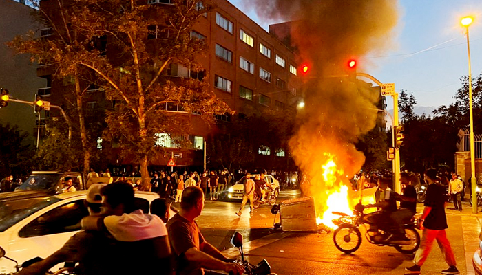 A police motorcycle burns during a protest over the death of Mahsa Amini, a woman who died after being arrested by the Islamic republics morality police, in Tehran, Iran September 19, 2022. — Reuters