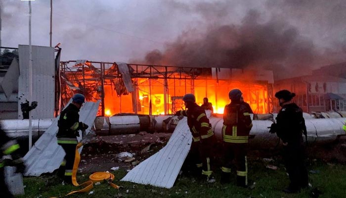 Firefighters work at the site of a car retailer office building, destroyed during a Russian missile attack in Zaporizhzhia, Ukraine October 11, 2022. — Reuters