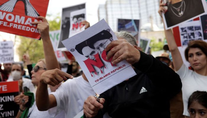 A demonstrator burns a poster during a protest following the death of Mahsa Amini, near the Iranian consulate in Istanbul, Turkey October 4, 2022.— Reuters