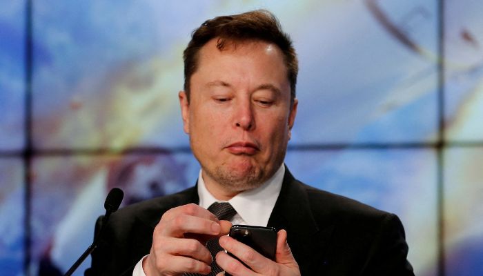 Elon Musk looks at his mobile phone in Cape Canaveral, Florida, U.S. January 19, 2020.— Reuters