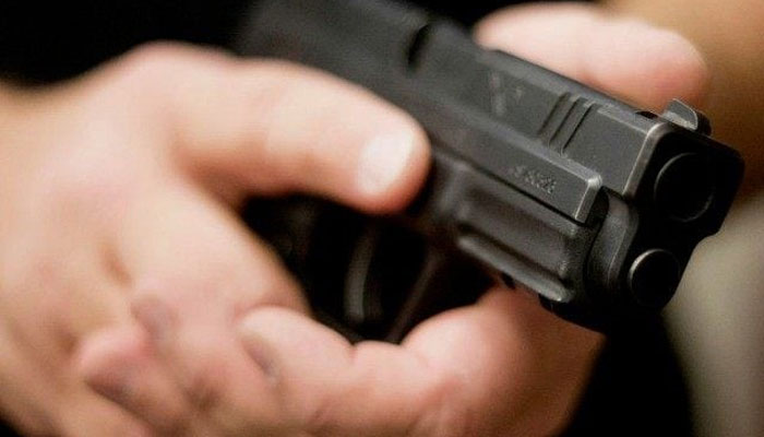Representational image of a man holding a gun. — Reuters