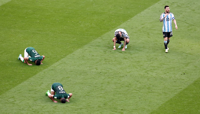 Argentinas Lionel Messi reacts as Saudi Arabias Abdulellah Al-Malki and Mohammed Al Burayk celebrate after the match. — Reuters