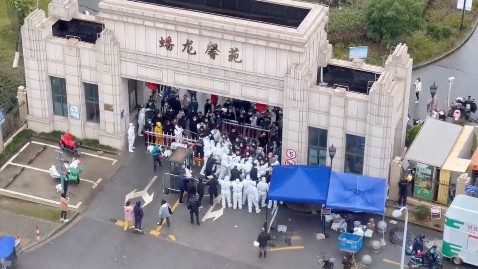 Residents confront workers donned in protective suits who are blocking the entrance of a residential compound, amid the coronavirus disease (COVID-19) outbreak in Shanghai, China, in this still image obtained from a social media video released November 30, 2022.— reuters