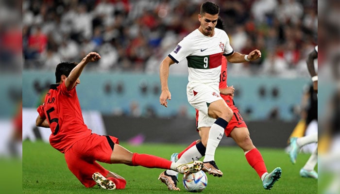 South Korea’s midfielder #05 Jung Woo-young fights for the ball with Portugal´s forward #09 Andre Silva during the Qatar 2022 World Cup Group H football match between South Korea and Portugal at the Education City Stadium in Al-Rayyan on December 2, 2022. — AFP