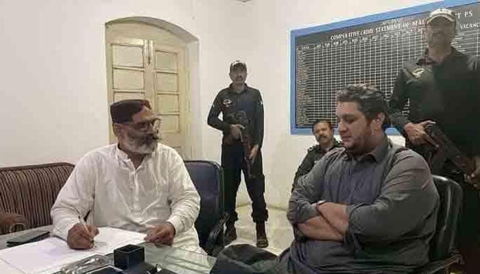 PPP MPA Jam Awais (right) is seen sitting at a police station for statement after his arrest in Nazim Jokhio murder case. — Twitter/@Xadeejournalist