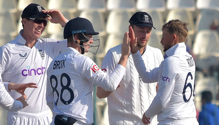 English bowler Joe Root celebrates after taking the wicket of Fahim Ashraf on Monday. —PCB