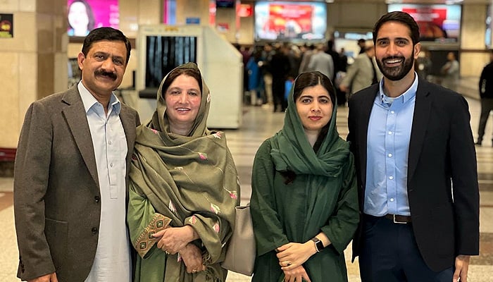 Malala Yousafzai pictured along with her family members upon arrival at the Lahores Allama Iqbal Airport on Tuesday. — Twitter