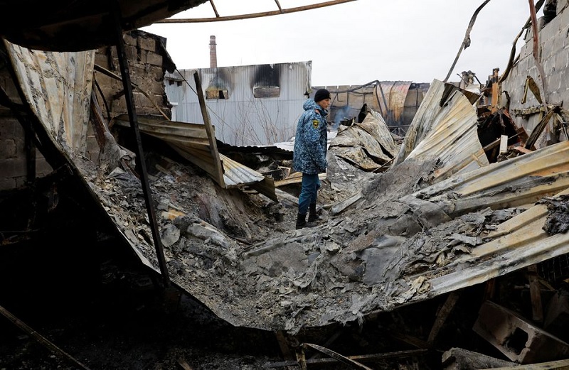 An emergencies ministry member walks at a local market hit by shelling in the course of Russia-Ukraine conflict in Donetsk, Russian-controlled Ukraine, December 12, 2022.