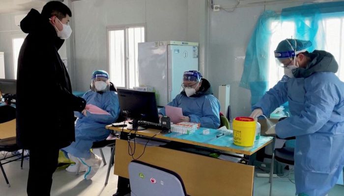 A health worker registers a resident for a nasal spray COVID-19 booster vaccine in Beijing, China December 17, 2022 in this still image obtained from a video.— Reuters
