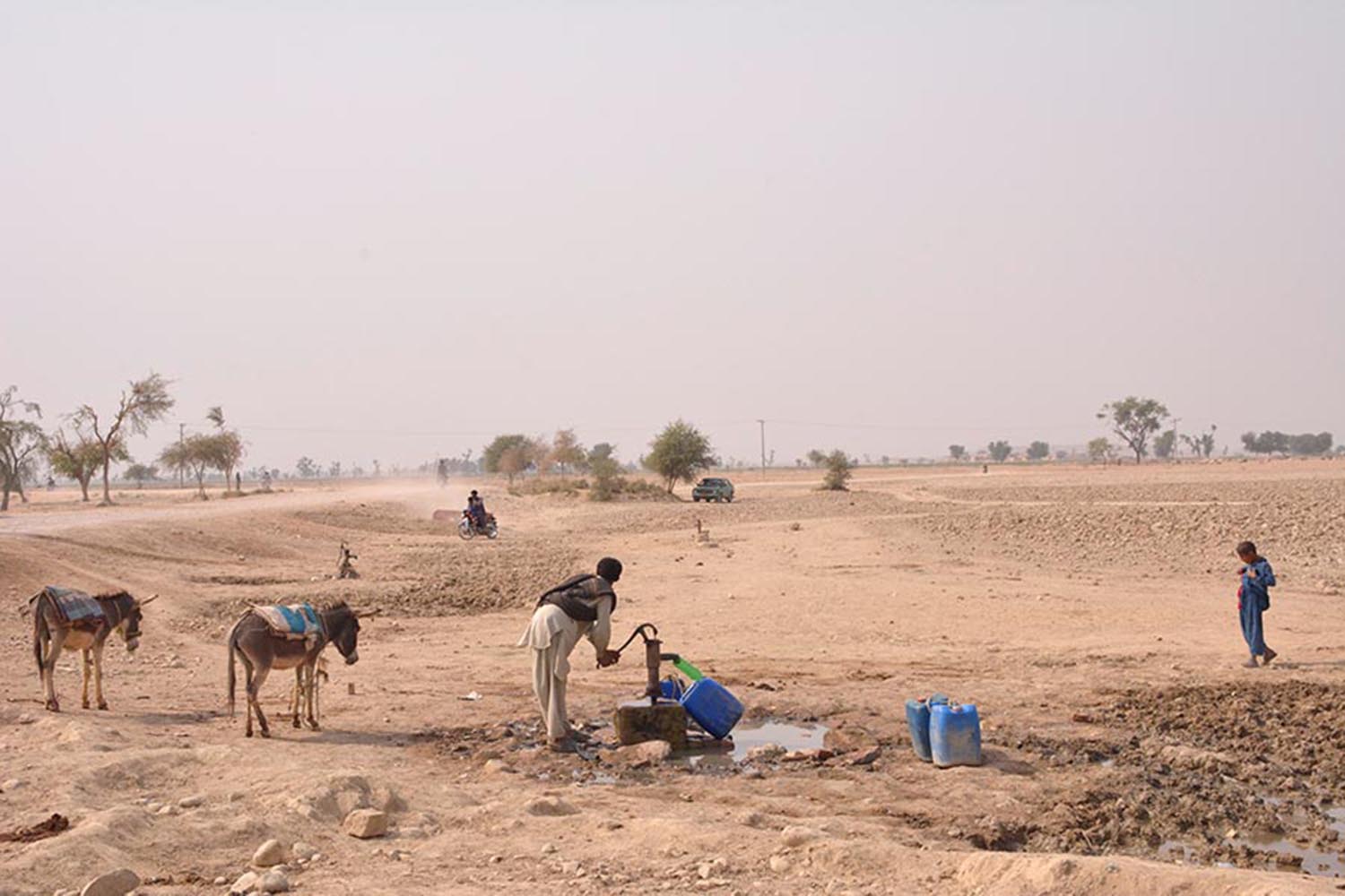A man is seen filling his jerrycan from a hand pump in interior Sindh. —Geo.tv/File