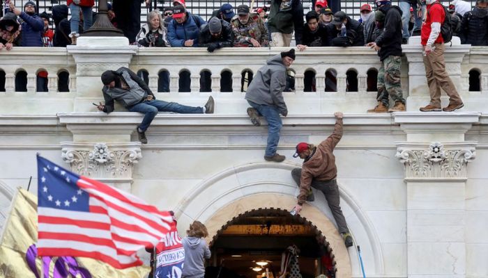 A mob of supporters of U.S. President Donald Trump fight with members of law enforcement at a door they broke open as they storm the U.S. Capitol Building in Washington, U.S., January 6, 2021.— Reuters