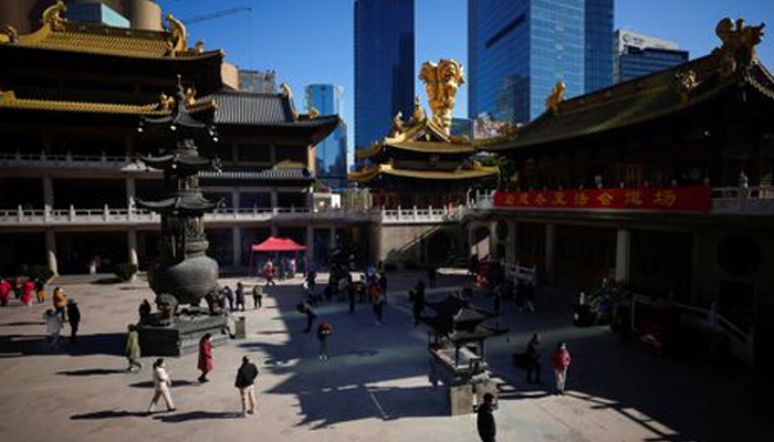 People wearing protective masks worship at the Buddhist Jingan Temple, as coronavirus disease (COVID-19) outbreaks continue in Shanghai, China, December 23, 2022. — Reuters