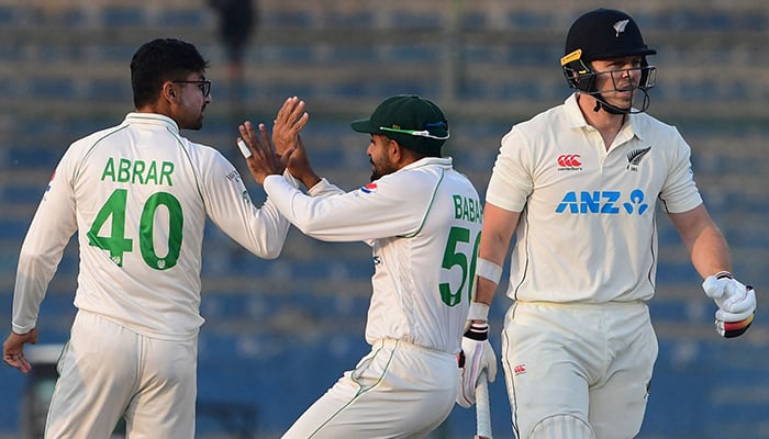 Pakistans Abrar Ahmed (left) celebrates after taking the wicket of New Zealands Michael Bracewell (right) during the fifth and final day of the first Test match between Pakistan and New Zealand at the National Stadium in Karachi on December 30, 2022. — AFP