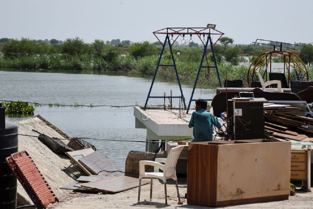 A man sits with his belongings on the roof of his house in a flooded residential area in Hyderabad, September 5, 2022. — Reuters/File