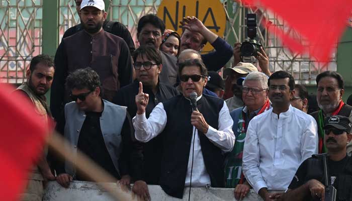 Former prime minister Imran Khan (centre) addresses his supporters during an anti-government march in Muridke on October 30, 2022. — AFP