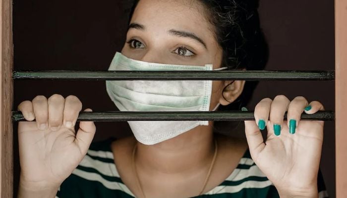 Woman in Green and White Stripe Shirt Covering Her Face With White Mask.— Pexels