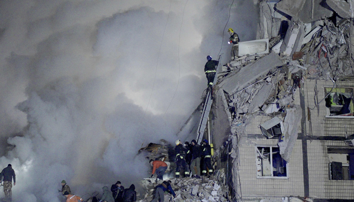 Rescuers works on a residential building destroyed after a missile strike, in Dnipro.— AFP