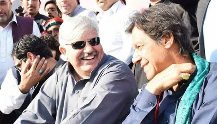 Khyber Pakhtunkhwa Chief Minister (left) and PTI Chairman Imran Khan can be seen having a conversation in this undated photo. — Twitter/@ptilawyer1/File