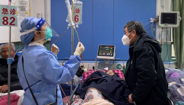 A medical worker checks the IV drip treatment of a patient lying on a bed in the emergency department of a hospital, amid the coronavirus disease (COVID-19) outbreak in Shanghai, China, January 5, 2023.— Reuters