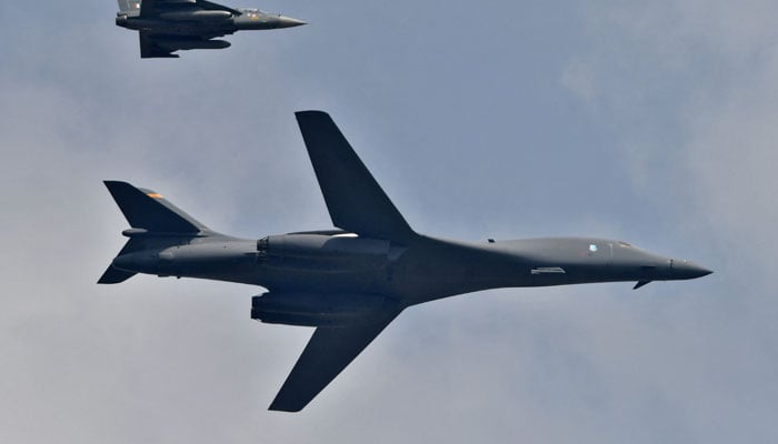 A US Air Force B-1B Lancer bomber and an Indian Air Force light combat aircraft Tejas fly during the Aero India 2021 air show at Yelahanka air base in Bengaluru, India, February 3, 2021. — Reuters