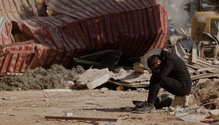 A man reacts as people search the rubble of collapsed apartment blocks for personal belongings, in the aftermath of a deadly earthquake, in Kahramanmaras, Turkey, February 18, 2023.— Reuters