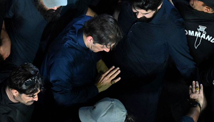 Pakistans ousted prime minister Imran Khan (C) arrives at Lahore High Court to appear before the court for protective bail in two cases in Lahore on February 20, 2023. &mdash; AFP