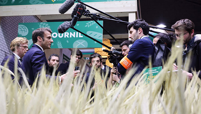 French President Emmanuel Macron (2ndL) and Minister of Agriculture Marc Fesneau talk to the press during the International Agriculture Fair in Paris on February 25, 2023, on the first day of the 59th edition of the fair. AFP