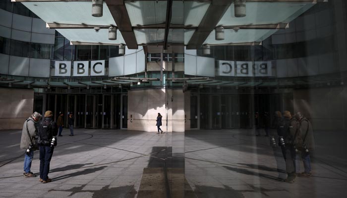 People stand outside the British Broadcasting Corporation (BBC) headquarters in London, Britain, March 13, 2023. — Reuters