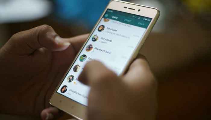 A representational image of a person using WhatsApp on phone. — AFP/File