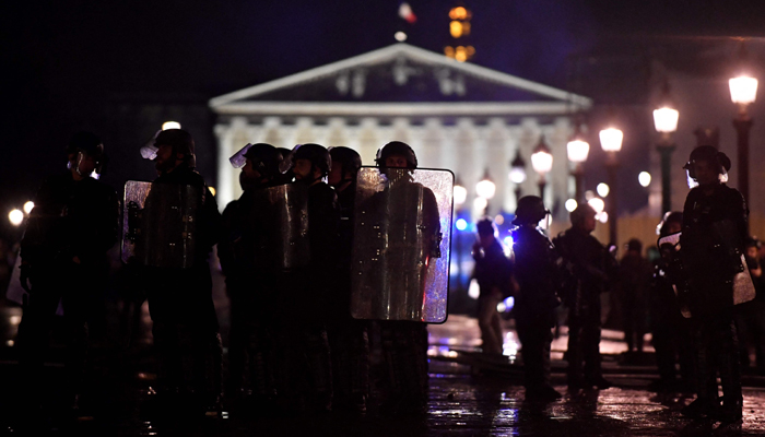Police officers block access to the French National Assembly building during a demonstration on Place de la Concorde in Paris, the day after the French government pushed a pensions reform using article 49.3 of the constitution on March 17, 2023. — AFP