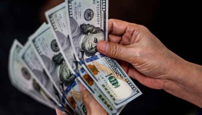 A person shows U.S. dollars at a currency exchange store in Manila, Philippines, October 21, 2022. — Reuters