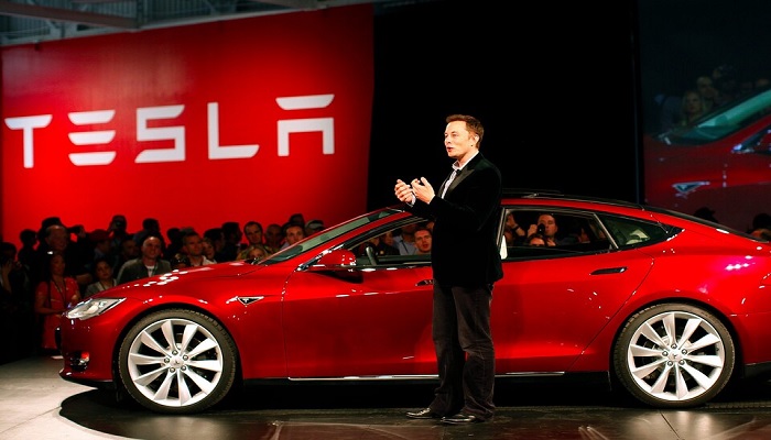 Elon Musk speaks at the launch of a Tesla car. — Twitter