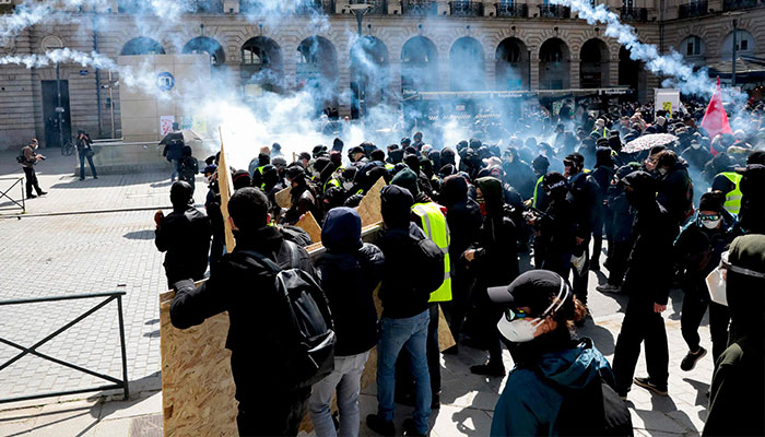 Protestors clash with police officers during a demonstration against the French Government´s pension reform hours after it was signed into law in Rennes, western France, on April 15, 2023.