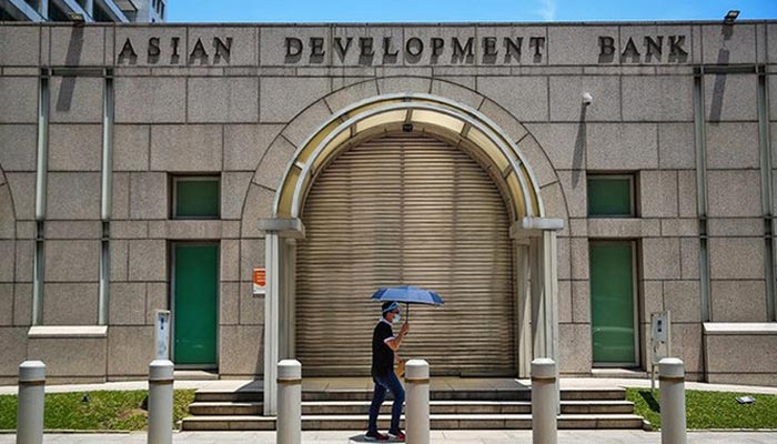 A man walks past the Asian Development Bank (ADB) building in Ortigas City, Philippines on October 8, 2021. — Reuters