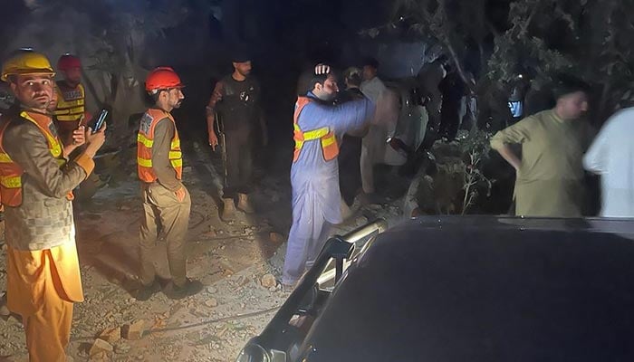 Security personnel gather at the site after multiple explosions caused by a fire in a munitions cache in a police station in Kabal, in the Swat Valley, on April 24, 2023. — AFP