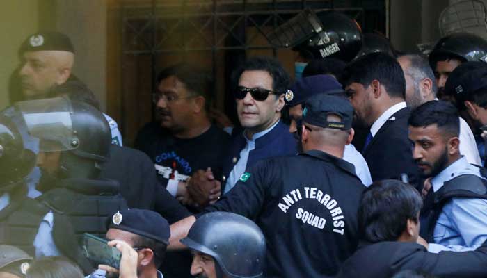 Security officers escort Pakistans former Prime Minister Imran Khan, as he appeared in Islamabad High Court, Islamabad, Pakistan May 12, 2023. — Reuters