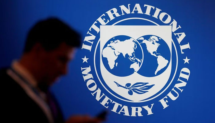 A participant stands near a logo of IMF at the International Monetary Fund - World Bank Annual Meeting 2018 in Nusa Dua, Bali, Indonesia, October 12, 2018. — Reuters