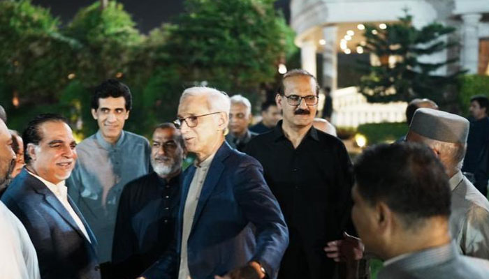 Aamer Mehmood Kiani can be seen behind Jahangir Tareen at the dinner hosted by Aleem Khan at his residence. — Twitter/@SHABAZGIL